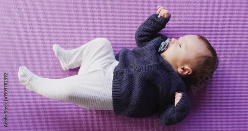 Video of caucasian newborn baby sleeping on violet blanket
