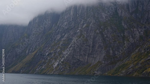 Fog descending on cliffs bordering western brook pond in gros morne national park, newfoundland, canada