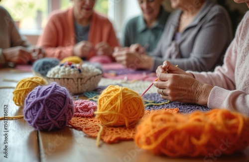 Elderly women friends gather in cozy crochet club. Ladies knit colorful wool threads. Creative hobby, needlecraft, handmade textile art on wooden table. Handmade friendship, leisure time, cozy