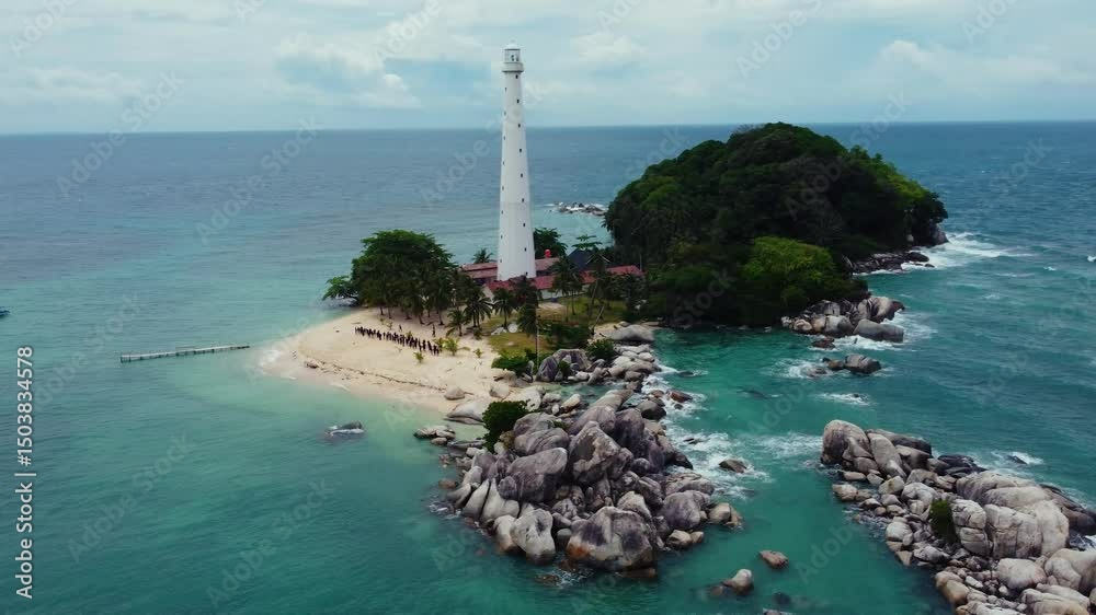 Aerial View of Light House at Lengkuas Island of Belitung Indonesia. Dramatic Tropical island with White Sandy beach and Trees. POI Point of Interest Drone Shot. Bird Eye View
