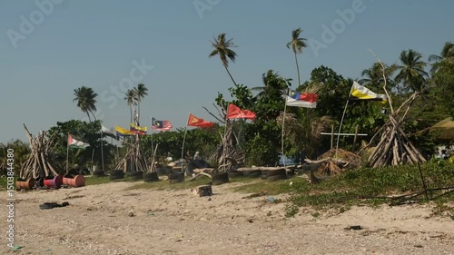 A handheld footage of waving Malaysia states flag at Tanjung Dawai seaside.