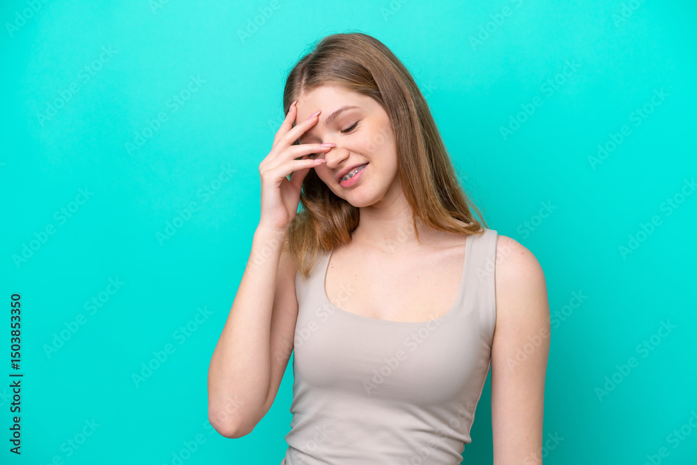 Fototapeta premium Teenager Russian girl isolated on blue background laughing