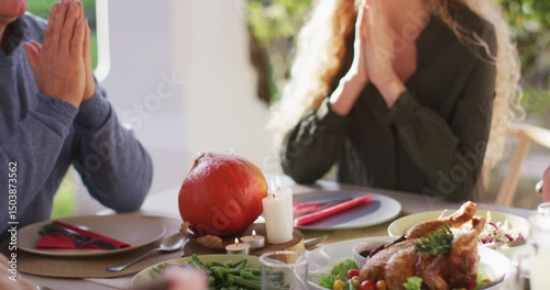 Video of happy caucasian daughter and senior father saying grace at table before family meal