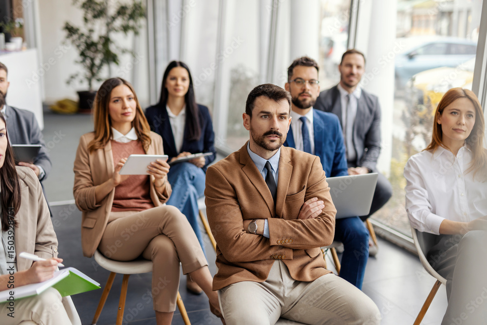 Group of managers sitting at boardroom on seminar and listening lecture. Group of managers sitting at boardroom on seminar and listening lecture.