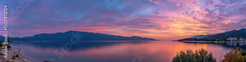 Serene Sunset over Coastal Mountains and Calm Sea, Vibrant Pink and Orange Sky