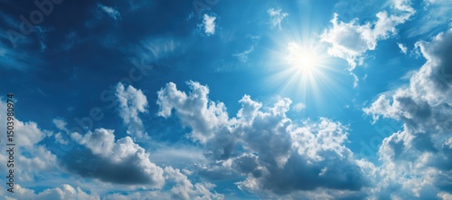 Bright Sun Shining Through Fluffy Cumulus Clouds in a Vivid Blue Sky, a Stunning Summer Day Scene