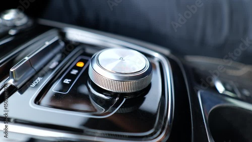 Driver Hand Adjusting Electronic Gear Knob in High-End Car. Futuristic Motion and Smooth Operation Highlight Automotive Innovation