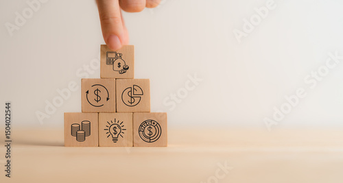 Budget and financial planning strategy concept. Wooden blocks with the icons related to budgeting, investment and financial strategy. Strategies for efficient budget allocation, budget management.