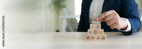 Budget and financial planning strategy concept. Wooden blocks with the icons related to budgeting, investment and financial strategy. Strategies for efficient budget allocation, budget management.
