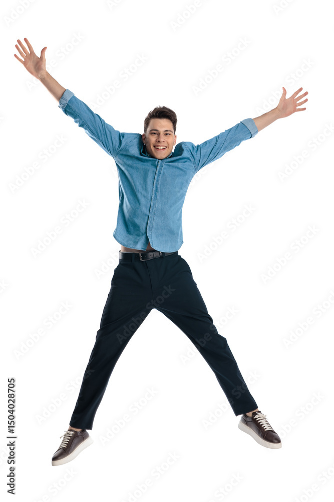 Obraz premium excited dynamic man in blue denim shirt with arms above head jumping
