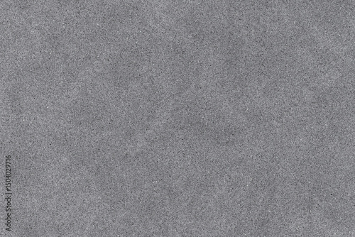abstract dark gray grainy texture resembling asphalt, fine concrete, or sandpaper