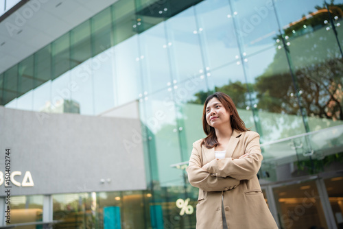 Asian business white collar confident woman standing outside office city building