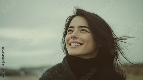 Smiling woman looking up,  beach background,  outdoor portrait