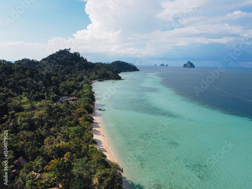 Aerial view of a pristine beach meeting vibrant jungle in Koh Kradan, Thailand, with white sand beach and coral reefs photo