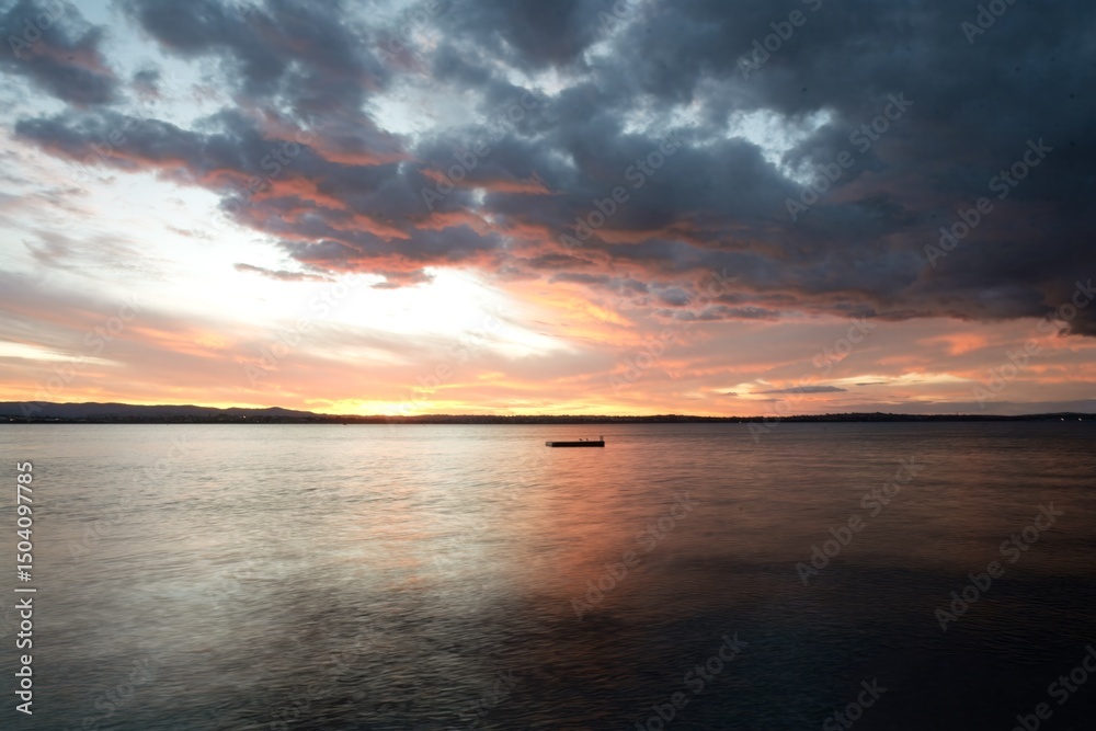 Naklejka premium Dramatic Red Sunset Sky over Pt Chevalier Beach