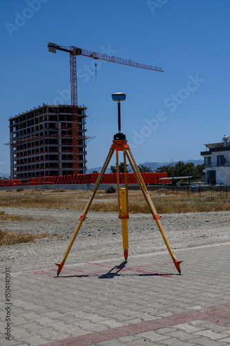Geodetic theodolite with GPS near building site on sunny day in Cyprus
