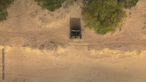 Wallpaper Mural Aerial View Capture of a Camouflaged Military Vehicle Positioned on Sandy Terrain and Surrounded by Lush Greenery Torontodigital.ca