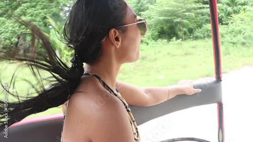 Young woman sitting in the sidecar of a moving motorbike, slow motion