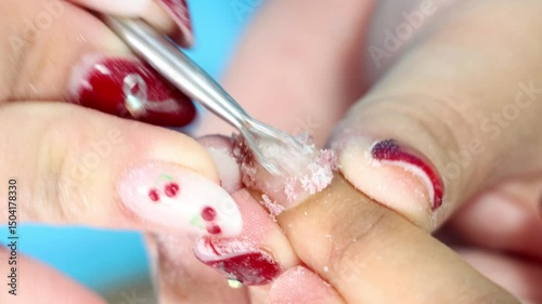 Nail treatment - gel nail removal in salon, close-up view