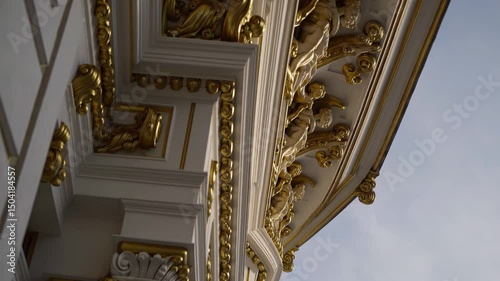 Ornate palace cornice with intricate gold detailing and classical architectural design


