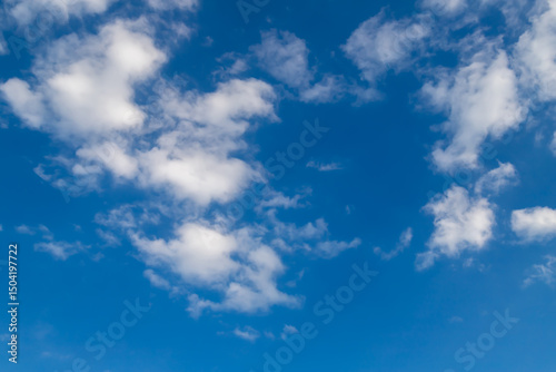 Bright Blue Sky with Soft White Clouds on a Clear Day