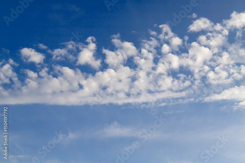 Serene Blue Sky with Soft White Clouds on a Clear Day