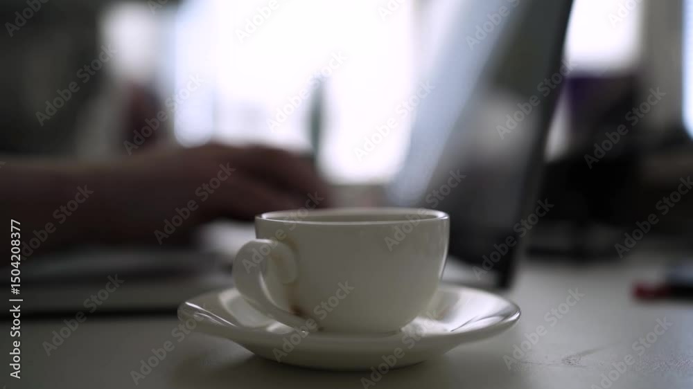 Office Desk Scene with Coffee Pouring from Moka Pot into White Cup Office Desk Scene with Coffee Pouring from Moka Pot into White Cup
