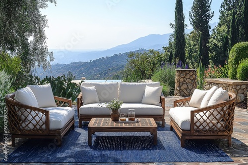 Three-piece outdoor furniture set with teak wood frame, white cushions, two armchairs, and coffee table on blue rug