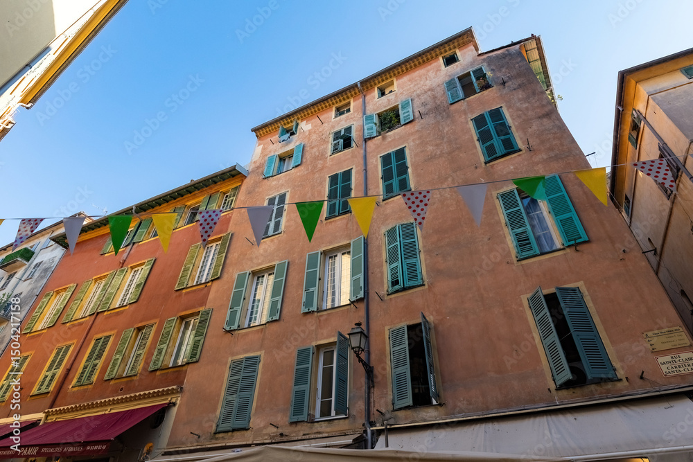 Old town house in Nice french architecture old house flags France Old town house in Nice french architecture old house flags France