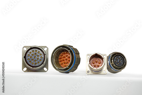 Papier peint Four industrial circular electrical connectors with multiple pins for secure power and signal connections in automation and machinery