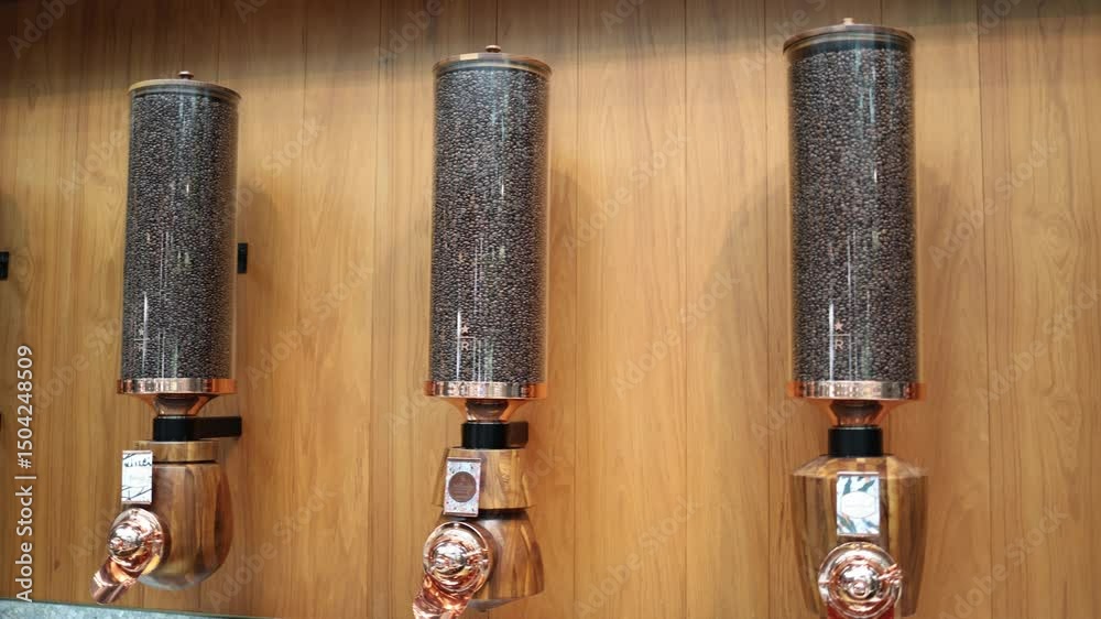 Coffee bean dispensers wood panel wall sleek copper accents modern cafe interior warm tones bulk storage elegant design artisanal vibe gourmet shop espresso bar detail