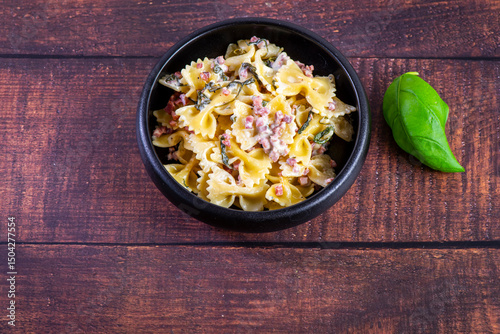 Carbonara pasta. Farfalle with pancetta, egg, parmesan cheese and cream sauce.