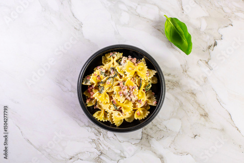 Carbonara pasta. Farfalle with pancetta, egg, parmesan cheese and cream sauce.