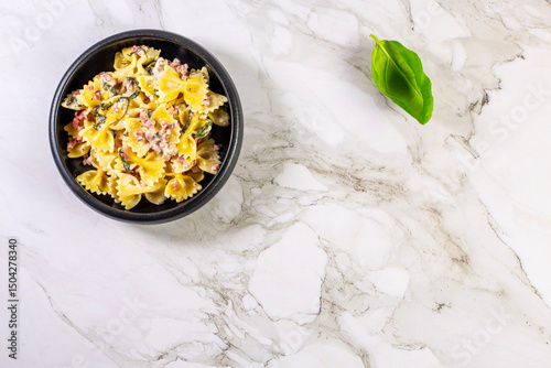 Carbonara pasta. Farfalle with pancetta, egg, parmesan cheese and cream sauce.