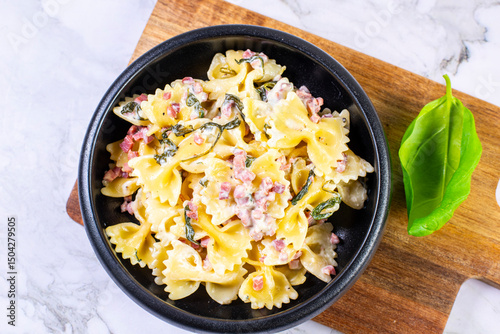 Carbonara pasta. Farfalle with pancetta, egg, parmesan cheese and cream sauce.