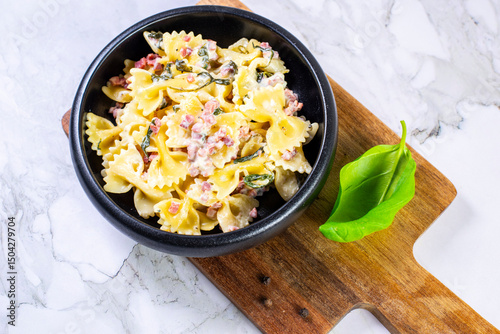Carbonara pasta. Farfalle with pancetta, egg, parmesan cheese and cream sauce.