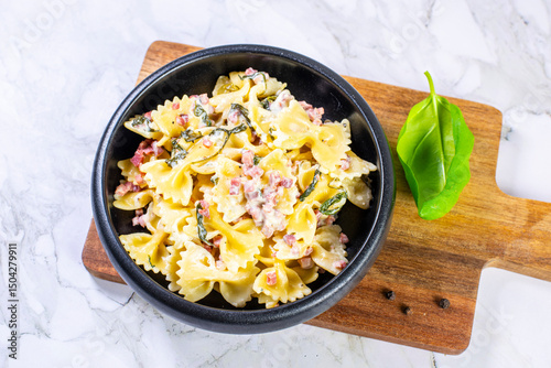 Carbonara pasta. Farfalle with pancetta, egg, parmesan cheese and cream sauce.
