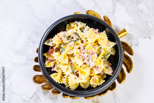 Carbonara pasta. Farfalle with pancetta, egg, parmesan cheese and cream sauce.