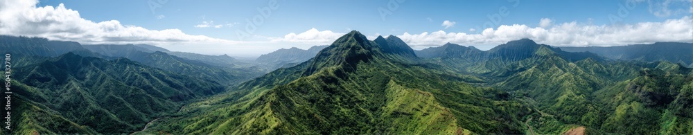 Fototapeta premium Scenic panorama of lush green mountain range under clear blue sky.
