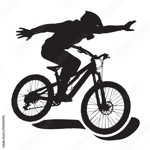 Silhouette of mountain biker performing a jump