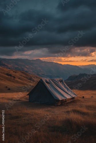 Beautiful Sunset Over a Tent in the Mountains With Rolling Hills and Dramatic...