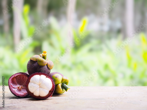 Ripe mangosteen on wooden table. Queen of fruits in Thailand