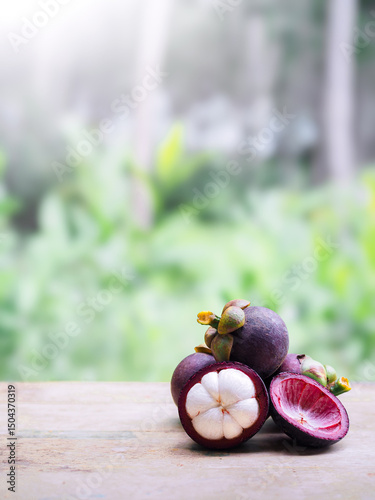 Fototapeta Naklejka Na Ścianę i Meble -  Ripe mangosteen on wooden table. Queen of fruits in Thailand