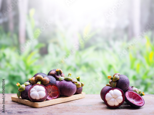 Ripe mangosteen on wooden table. Queen of fruits in Thailand