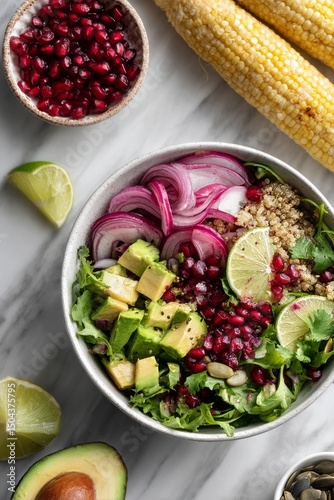 Delicious Healthy Bowl With Quinoa, Corn, Avocado, and Pomegranate on a Marbl...