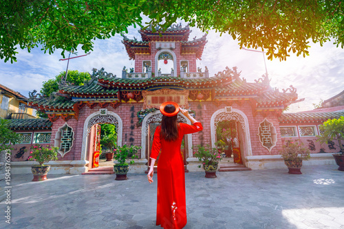 Asian female tourists visit Fukian Auditorium in Hoi An ancient town. Vietnam.