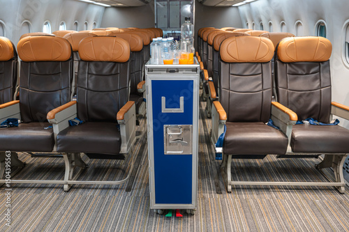 Inflight food meal cart on plane with empty passenger seats,  airline business concept