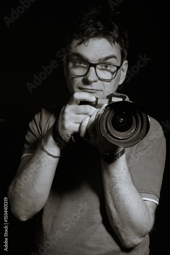 Photographer man in glasses and shirt with camera isolated