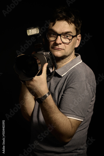 Photographer man in glasses and shirt with camera isolated