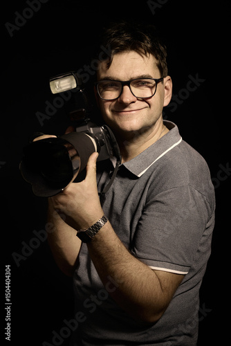 Photographer man in glasses and shirt with camera isolated
